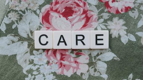 Tiles spelling out word CARE