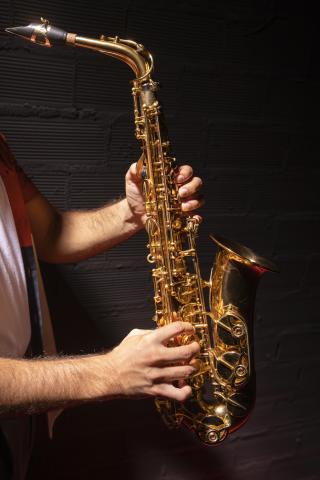 man holding saxophone