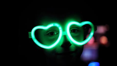 child wearing glow-in-the-dark heart-shaped frames