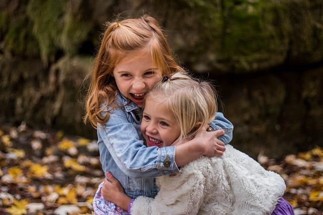 Two girls hugging and smiling